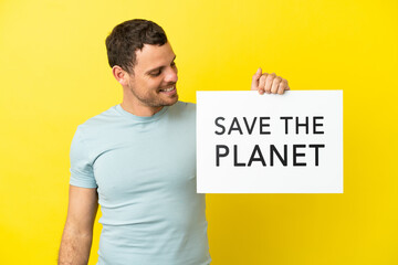 Brazilian man over isolated purple background holding a placard with text Save the Planet