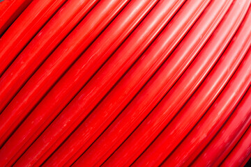 Red wire cable in reels close up background