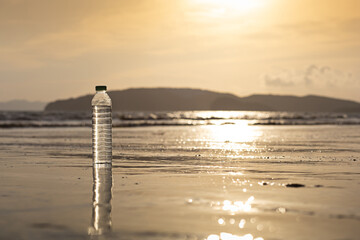 holiday concept Plastic water bottles on the beach of the sea