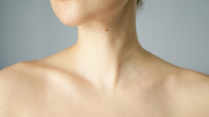 Woman with brown mole and nevus in collarbone area. Skin care concept. - obrazy, fototapety, plakaty