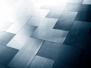 Modern shiny silver and blue metal sheet plates panel, grid pattern floor background, perspective view.