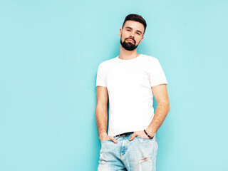 Portrait of handsome confident stylish hipster lambersexual model.Man dressed in white T-shirt and...