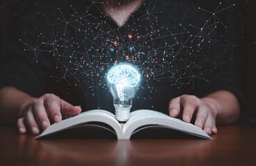 Glowing lightbulb with virtual brain on open book  and connection line for reading and education make smart or creative thinking idea concept. - obrazy, fototapety, plakaty