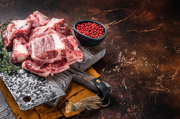 Butcher board with Raw diced beef and lamb meat ready for cooking. Dark background. Top view. Copy...