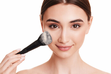 woman applying powder with make up brush