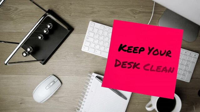 Animation of keep your desk clean text over computer keyboard with notebook and pen