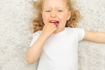 The child has a toothache. Children's caries in the initial stage.