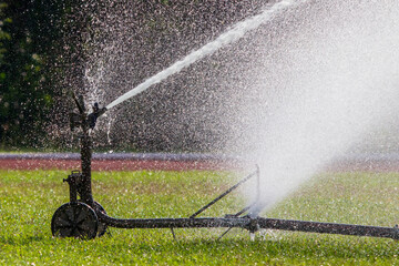 sprinkler head watering in park.
