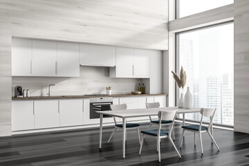 Corner view on dark kitchen room interior with dining table