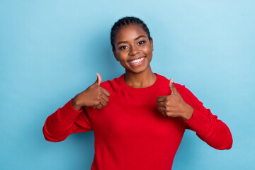 Photo of optimistic millennial braids hairdo lady thumb up wear red pullover isolated on blue color background - obrazy, fototapety, plakaty