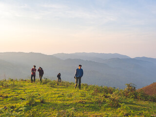 Obraz premium Trekking group enjoying on mountain trail in tropical forest at Tak Province, Thailand.