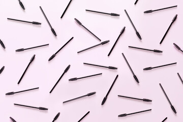 Set of brushes for eyelashes and eyebrows on pink background. Correction and care. Cooling and...