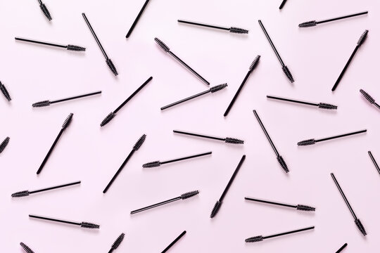 Set of brushes for eyelashes and eyebrows on pink background. Correction and care. Cooling and laying. Womens cosmetics.
