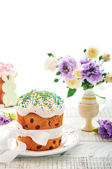 Traditional Easter sweet bread or cakes with white icing and sugar decor and quail eggs over white wooden table. Various Spring Easter cakes. Happy Easter day. Christian traditions.  Top view.