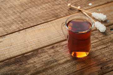 Turkish black tea. Glass cup of turkish black tea and crispy Turkish traditional bagel on old rustick background. Breakfast pastry concept. Traditional turkish brewed hot drink.