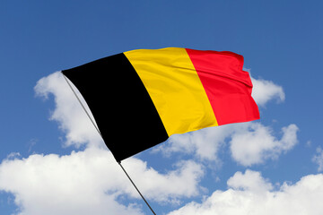 3d illustration. A beautiful view of Belgium flag on a blue sky background.
