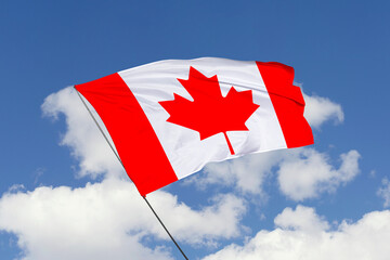 3d illustration. A beautiful view of Canada flag on a blue sky background.