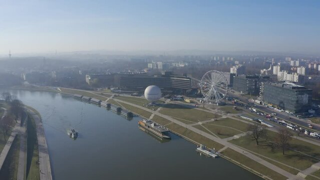 Krakow Poland. River Visla ( Vistula), ballon and Ferris wheel. Aerial video footage drone crosses the river and approaches the sights. panorama of the city from above. Sunrise fog