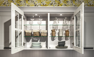 White kitchen cabinet with dishes, part of the kitchen interior.