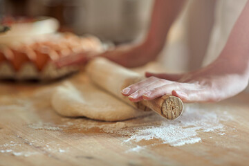 Get rolling. Cropped shot of a set of hands rolling out dough.