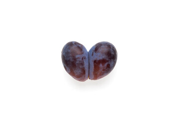 Ugly double prune or french plum in shape heart on white background. Concept - Ugly fruits. Reduction organic food waste