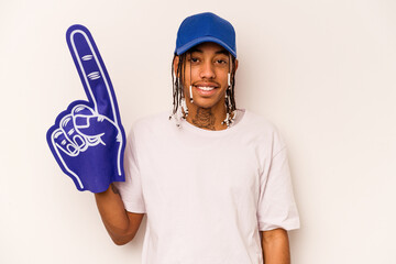 Young sports fan African American man isolated on white background laughing and having fun.