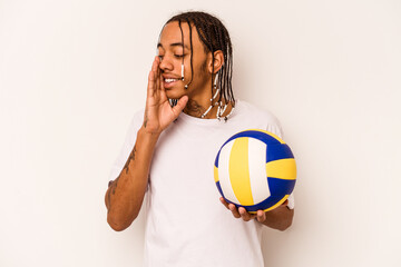 Young African American man playing volleyball isolated on white background shouting and holding palm near opened mouth.