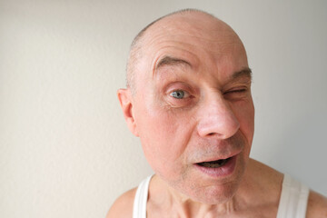close-up of mature charismatic man, senior 60 years surprised, puzzled, shocked by news, event,...