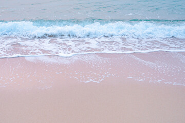 waves of the blue sea, turquoise sea waves breaking on the sandy coastline.  golden beach meeting deep blue ocean water and foamy waves.