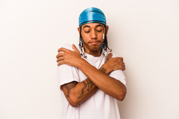 Young African American man isolated on white background hugs, smiling carefree and happy.