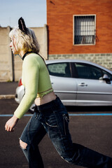 Young diverse woman outdoors riding longboard skating in the city