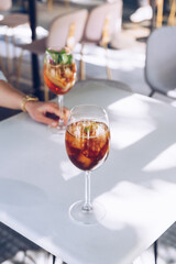 Woman is holding a glass of cocktail, summer days