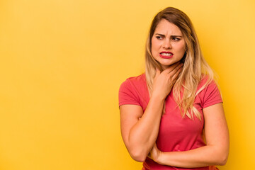 Young caucasian woman isolated on yellow background touching back of head, thinking and making a choice.