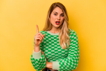 Young caucasian woman isolated on yellow background having an idea, inspiration concept.