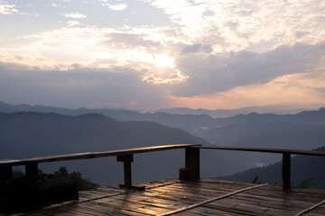 blured wood terrace with mountain ranges view, valley in the clouds