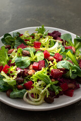 Warm salad with mixed salad with boiled beetroot and beans with spices