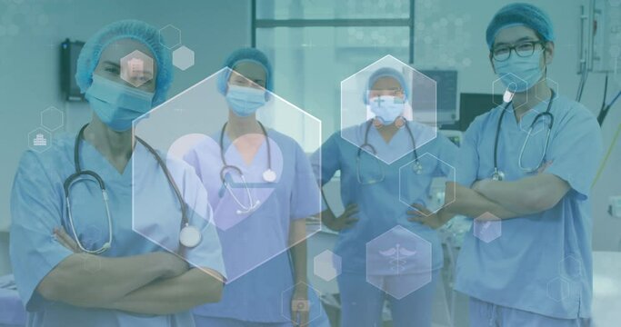 Animation of medical icons over diverse doctors wearing face masks
