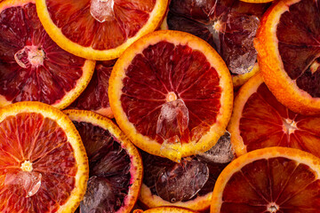 Fruit background with blood oranges and ice, delicious sweet fruit, top view