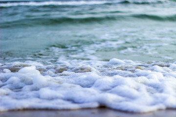 Ocean waves foaming on a beach