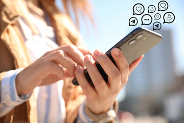 Different virtual icons and young woman using smartphone outdoors, closeup. SMM (Social media...