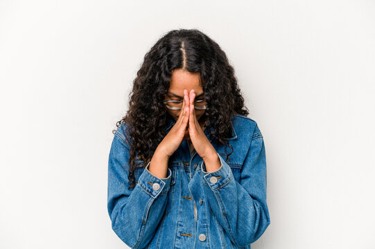 Young Hispanic Woman Isolated On White Background Praying, Showing Devotion, Religious Person Looking For Divine Inspiration.