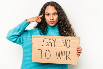 Young hispanic woman holding say no war placard isolated on white background