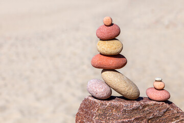 Rock zen pyramid of white, red and yellow stones. Concept of balance, harmony and meditation