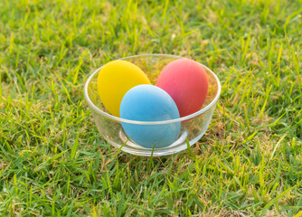 Colorful easter eggs on natural green grass background. Food decoration on holiday.