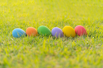 Colorful easter eggs on natural green grass background. Food decoration on holiday.