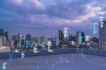 Rooftop with concrete terrace, Bangkok night skyline. Forecasting and business modeling of financial markets hologram digital charts. City downtown. Double exposure.