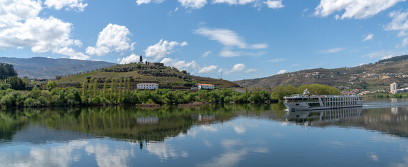 panorama view of a river cruise ship travel upstream on the Douro River