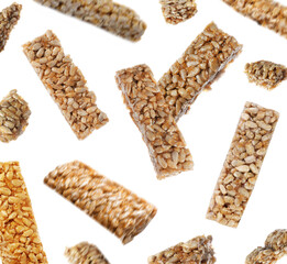 Tasty sweet kozinaki falling on white background