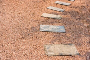 Zen stone path on gravel floor in the garden