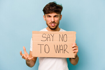 Young hispanic man holding say no war placard isolated on white background